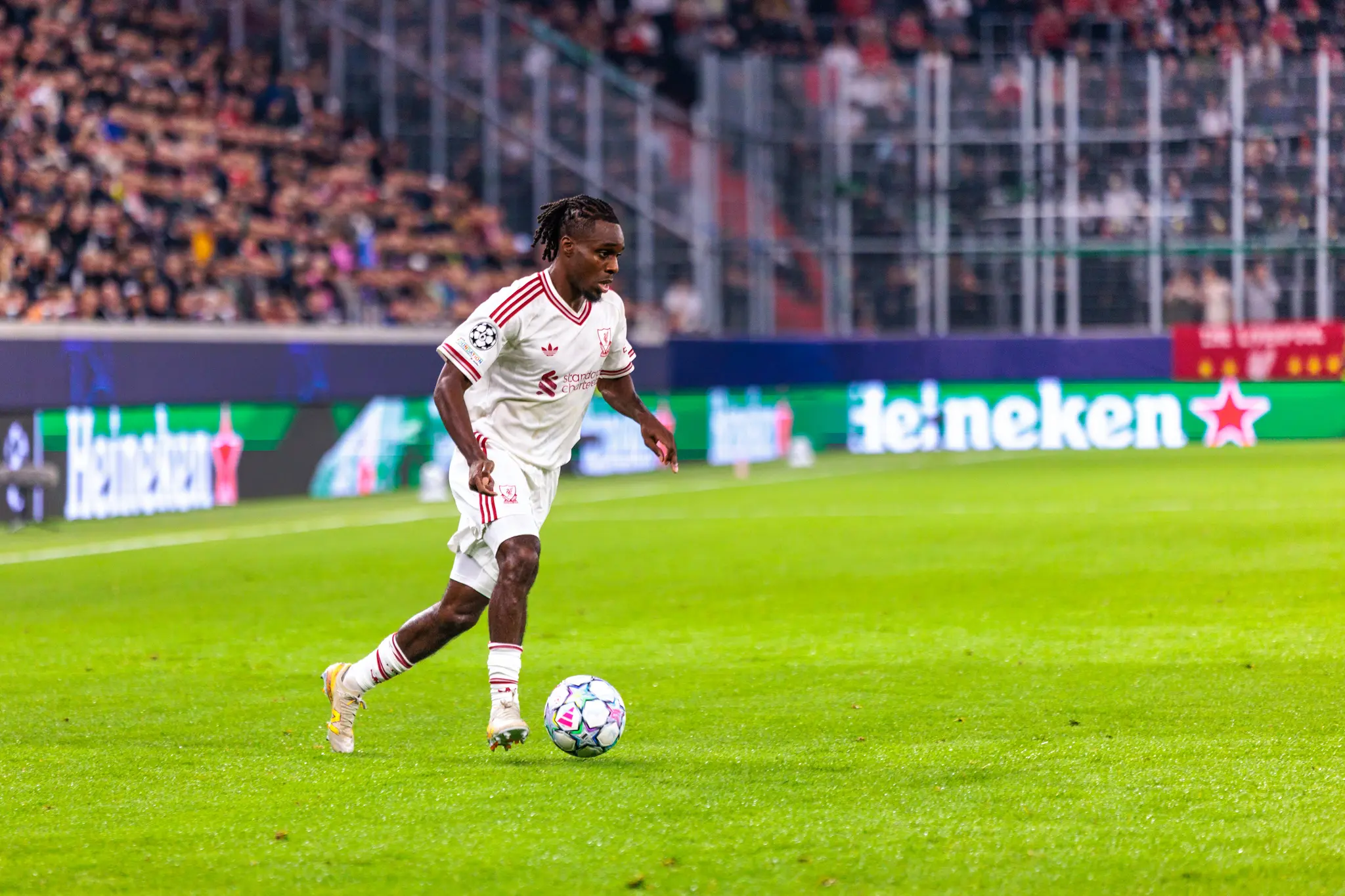 Rio Ngumoha (73) dribbelt mit dem Ball über den Rasen, links und rechts begleiten ihn LASK-Spieler.