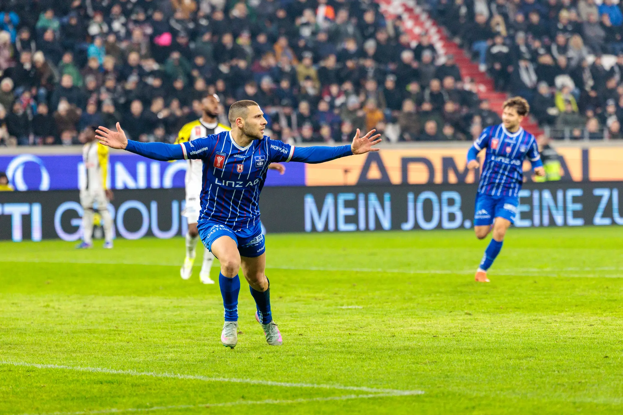 Stürmer Shon Weissman vom FC Blau-Weiß Linz bejubelt mit ausgebreiteten Armen seinen Treffer im emotionalen Linzer Derby des ÖFB Cups gegen den LASK