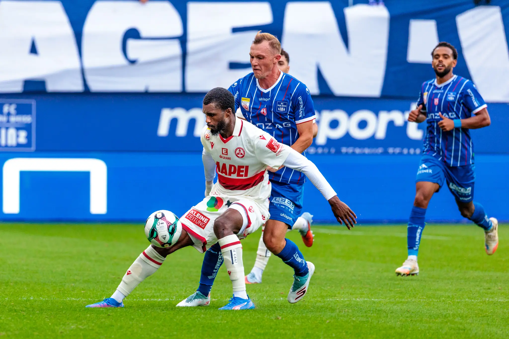 Sadik Fofana vom Grazer AK dribbelt den Ball unter Druck von Thomas Goiginger (FC Blau-Weiß Linz) in einem Bundesliga-Spiel