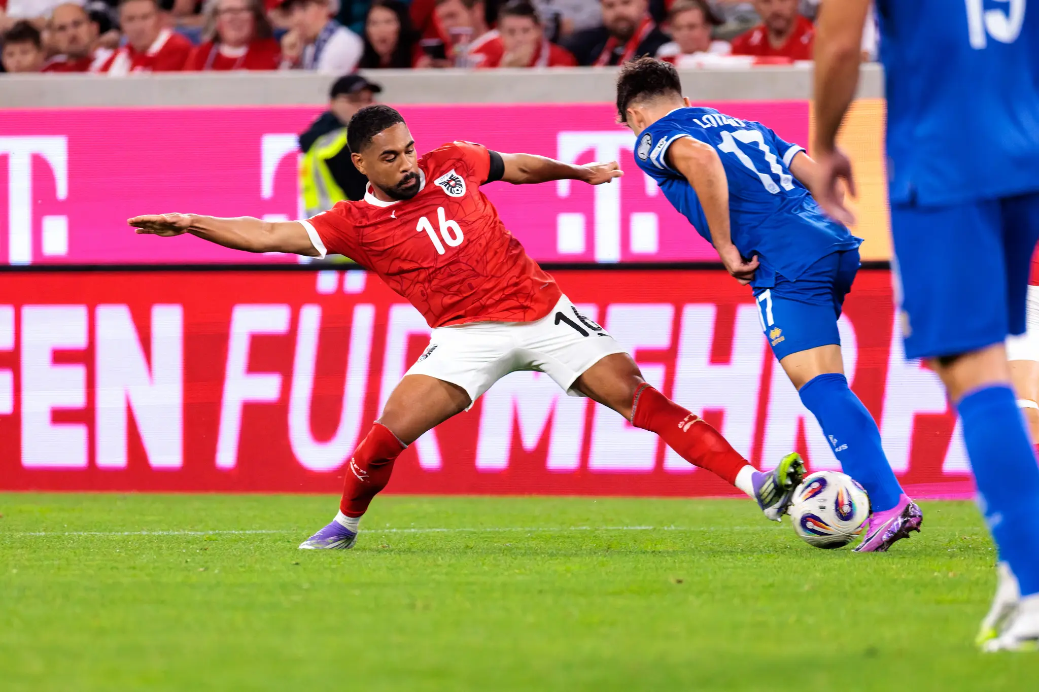 Österreichs Spieler Phillipp Mwene (Nr. 16) tackelt Zyperns Loizos Loizou (Nr. 17) im Kampf um den Ball während eines Fußballspiels