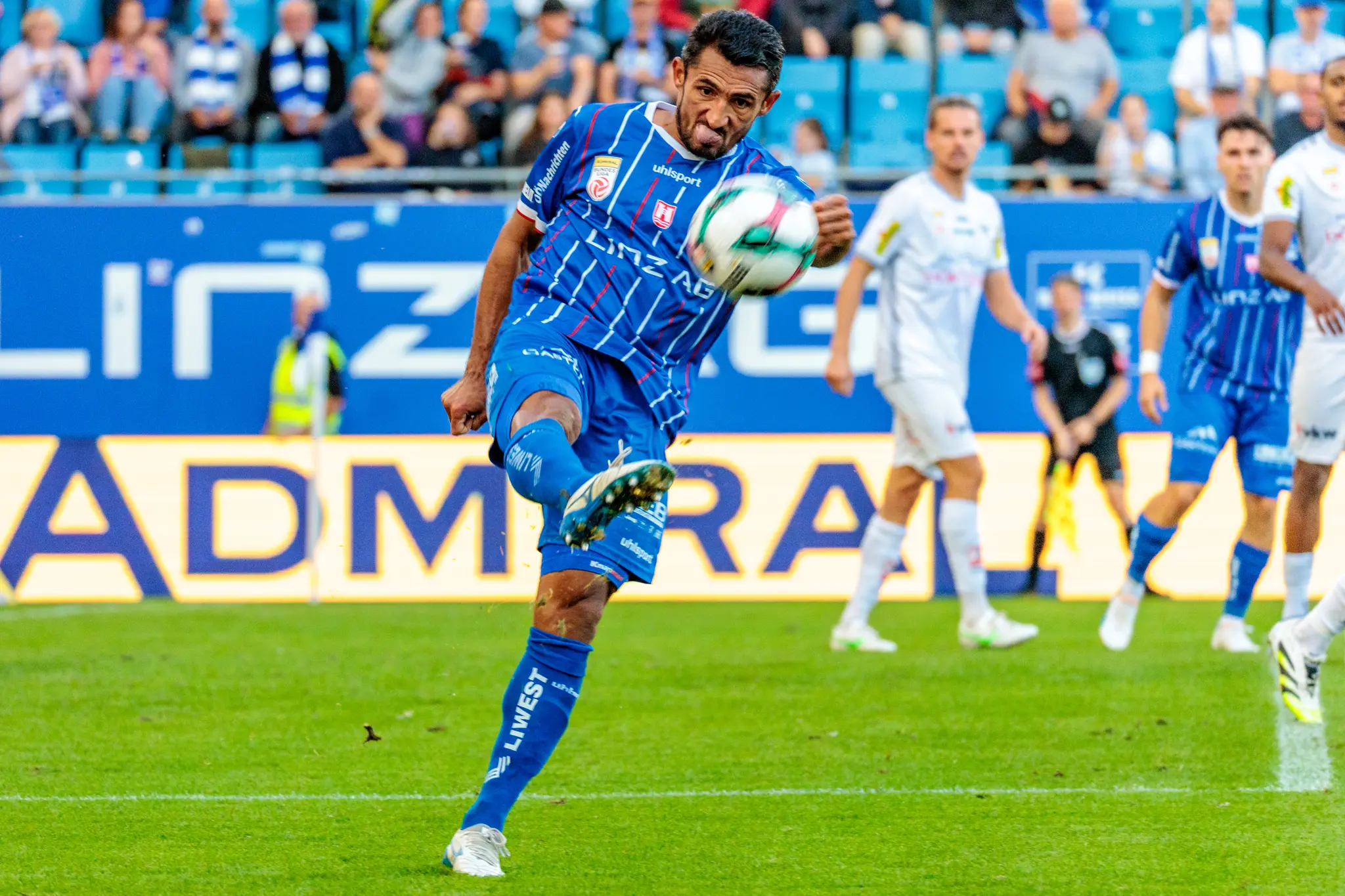 Der Fußballspieler Ronivaldo von Blau-Weiß Linz schießt den Ball mit entschlossenem Gesichtsausdruck während eines Bundesliga-Spiels im Donauparkstadion