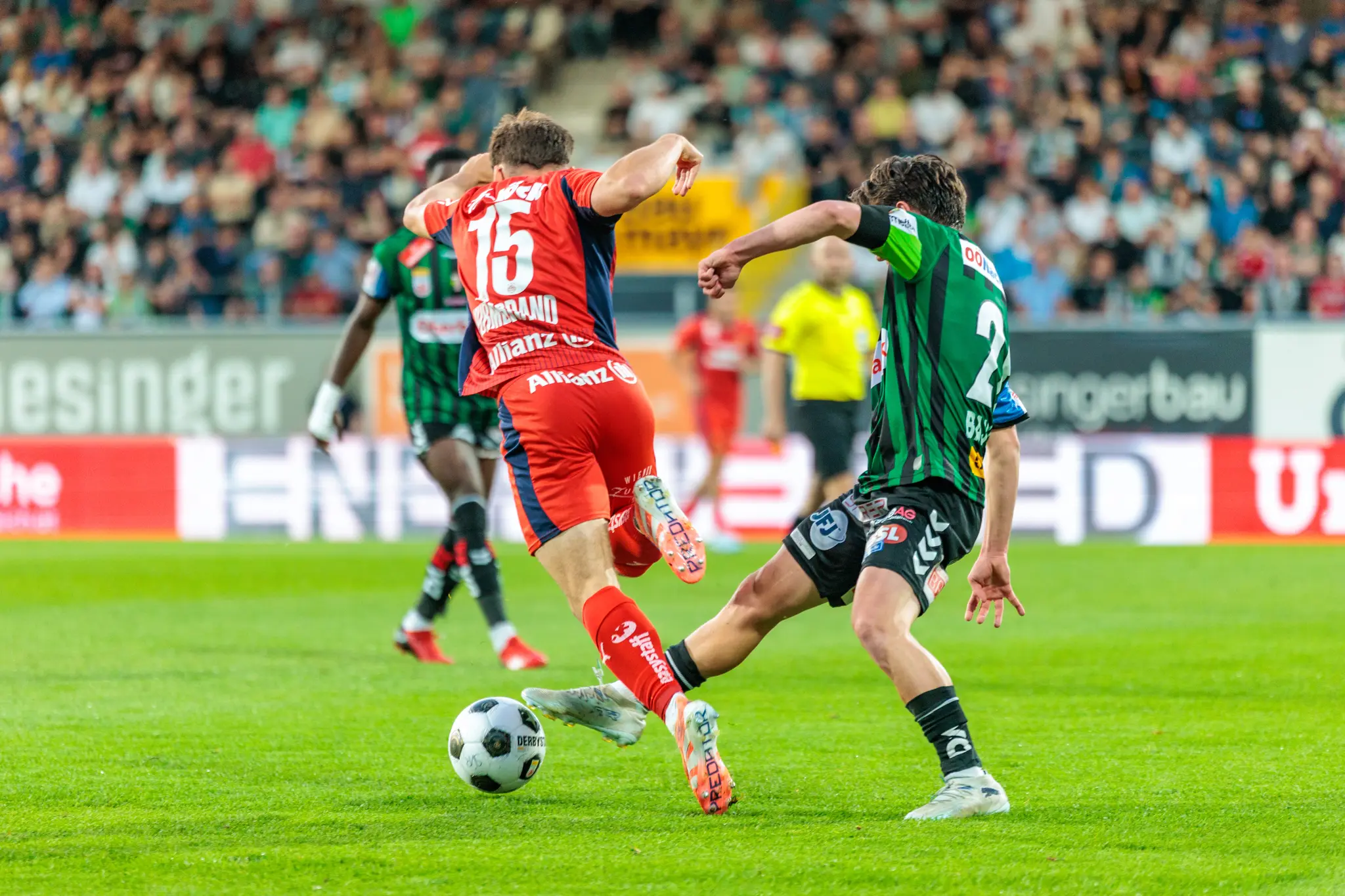 Ein intensiver Zweikampf zwischen einem Spieler von Rapid Wien und der SV Ried im Playoff-Hinspiel zur Bundesliga